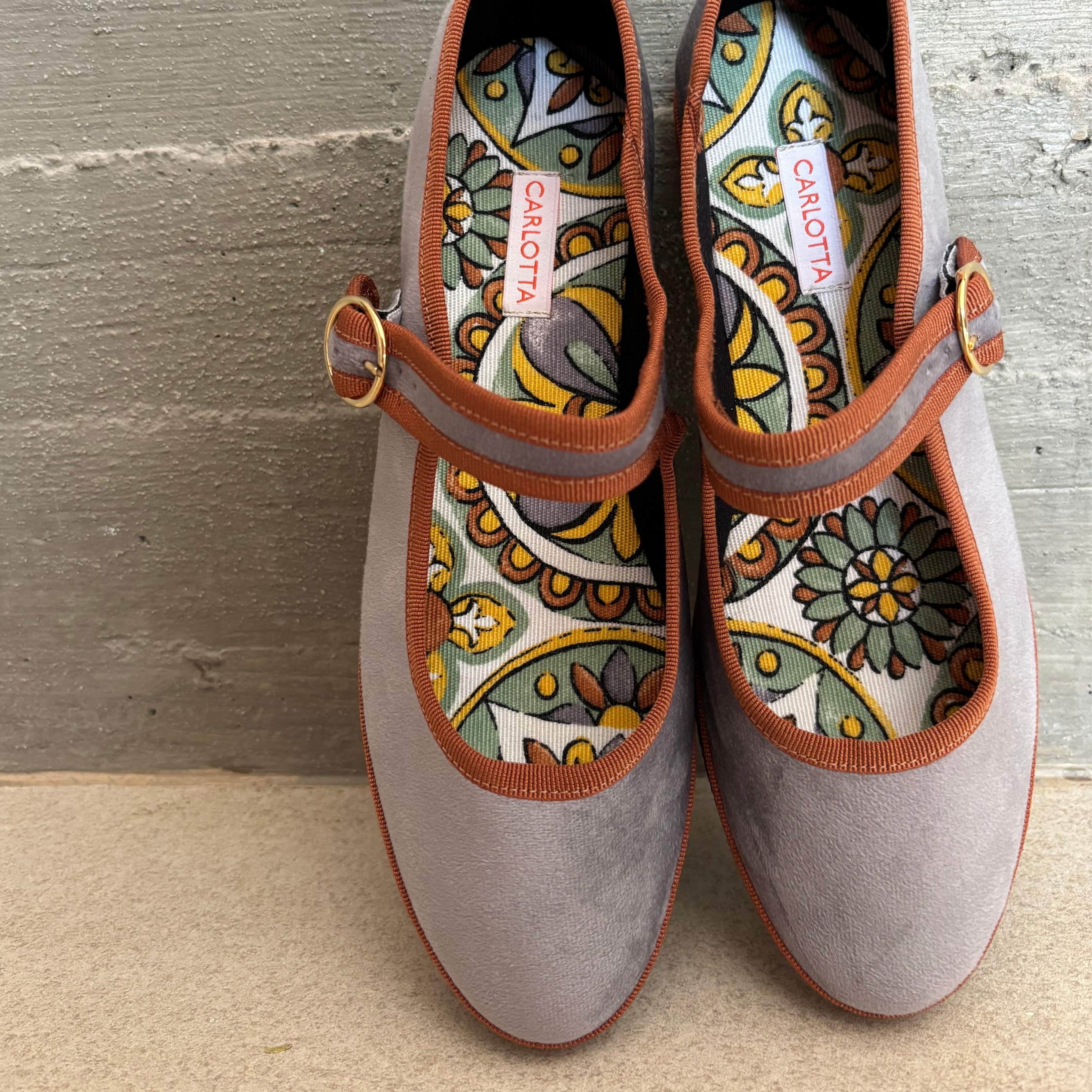 Vista lateral de zapatos Mary Jane Gris Tierra.